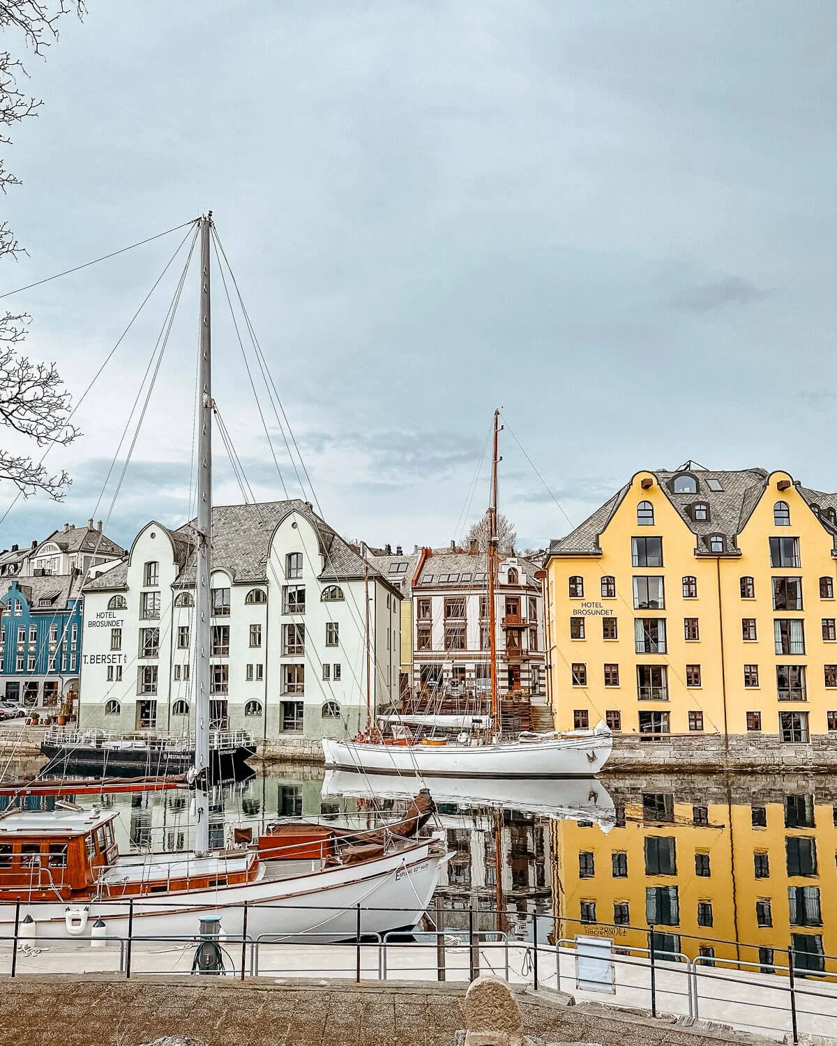 Art Nouveau buildings and boats along Brosundet canal Alesund Norway