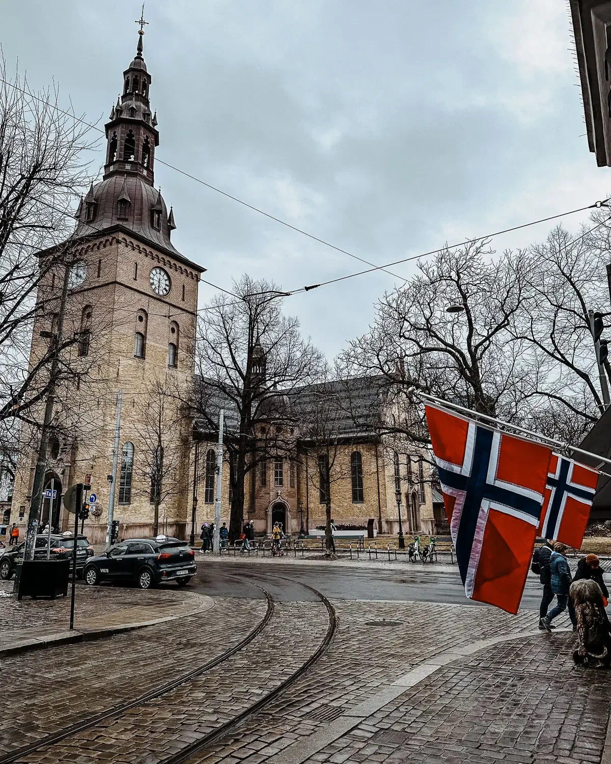 Oslo Cathedral with Norwegian flags and cobblestone streets Oslo Norway