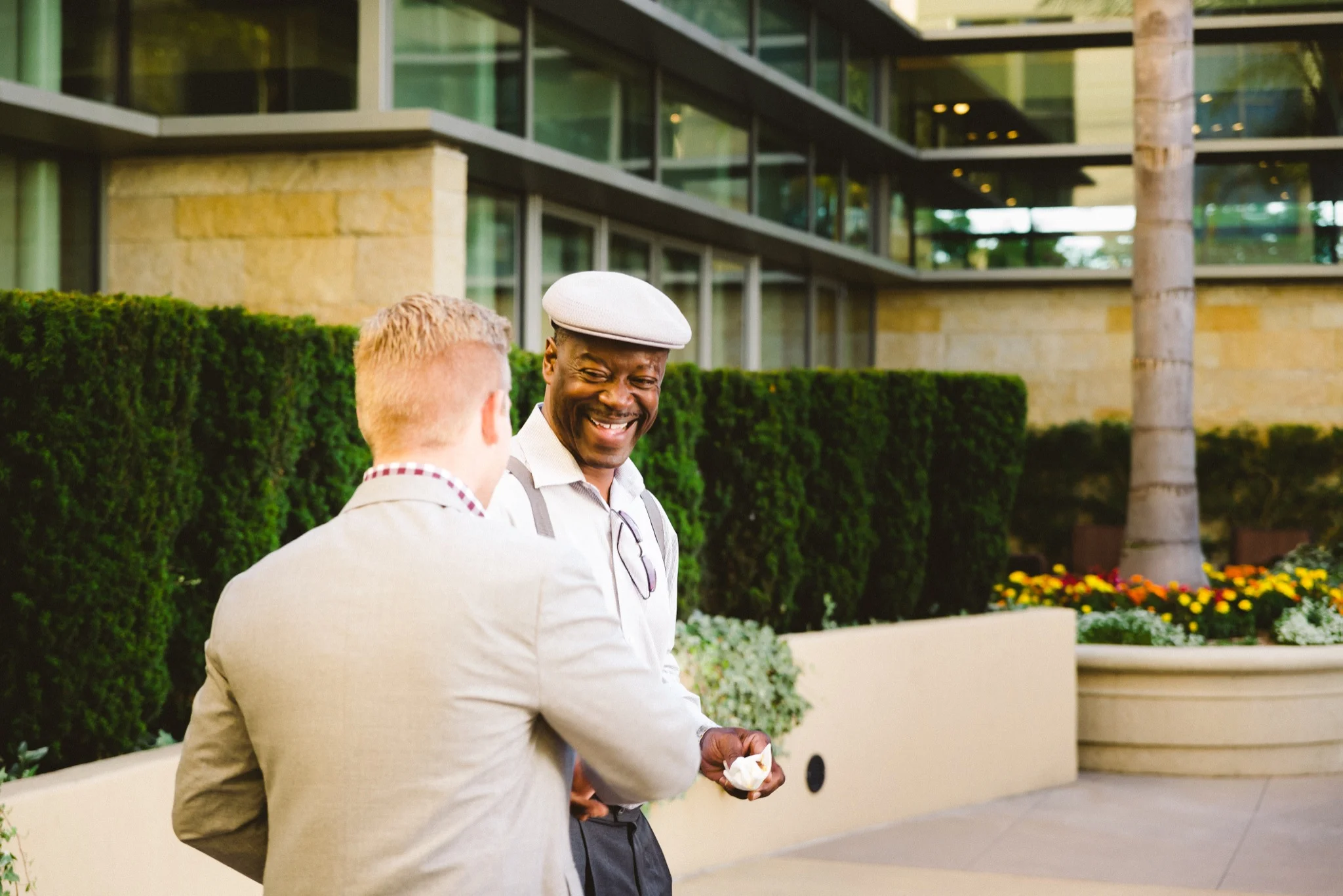 Happy African American man shaking hands with BMW sales representative