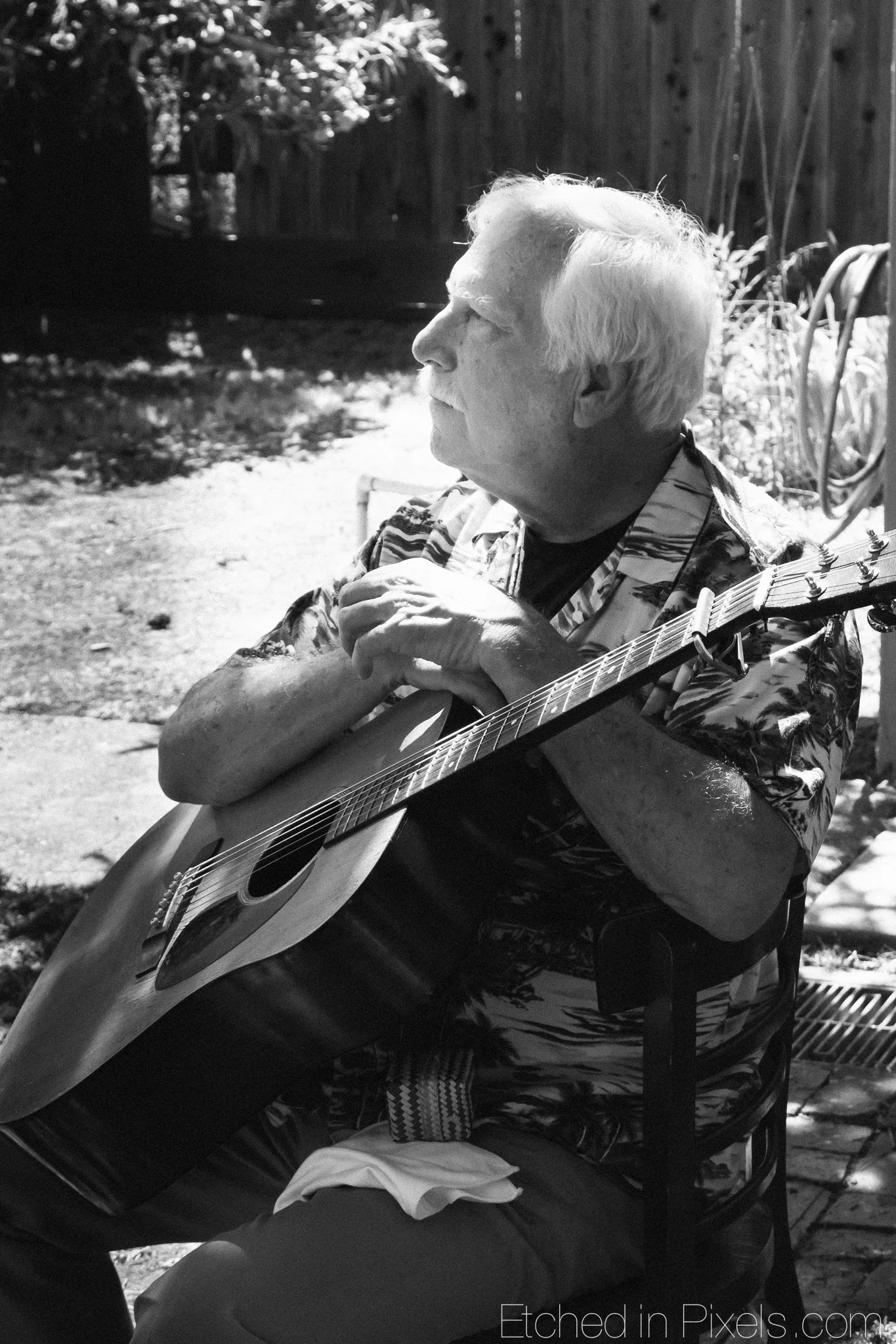 Herb More resets his arms on his guitar.