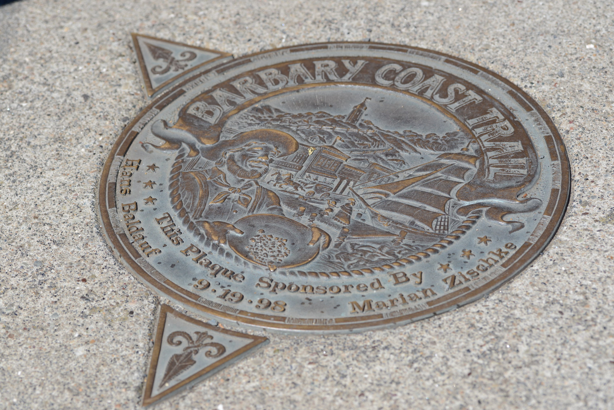 Medallions in the sidewalk indicate which way the trail turns. 