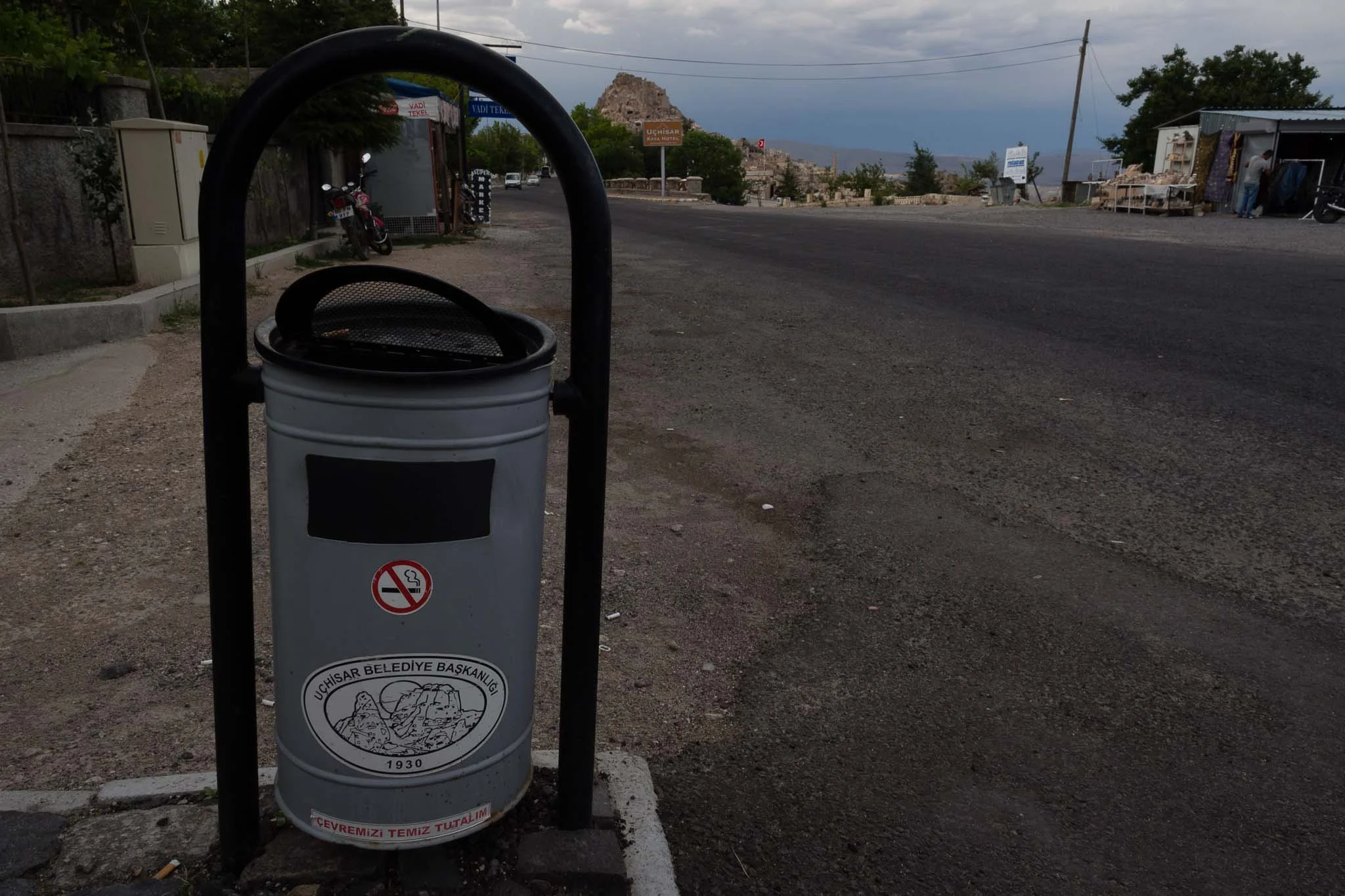 A roadside bin in the Cappadokia region of Central Turkey. Note the cave dwellings in the mountain behind it.