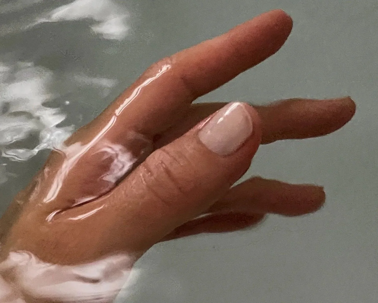 A hand in water illustrating Jodie Abrahams In Your Skin programme