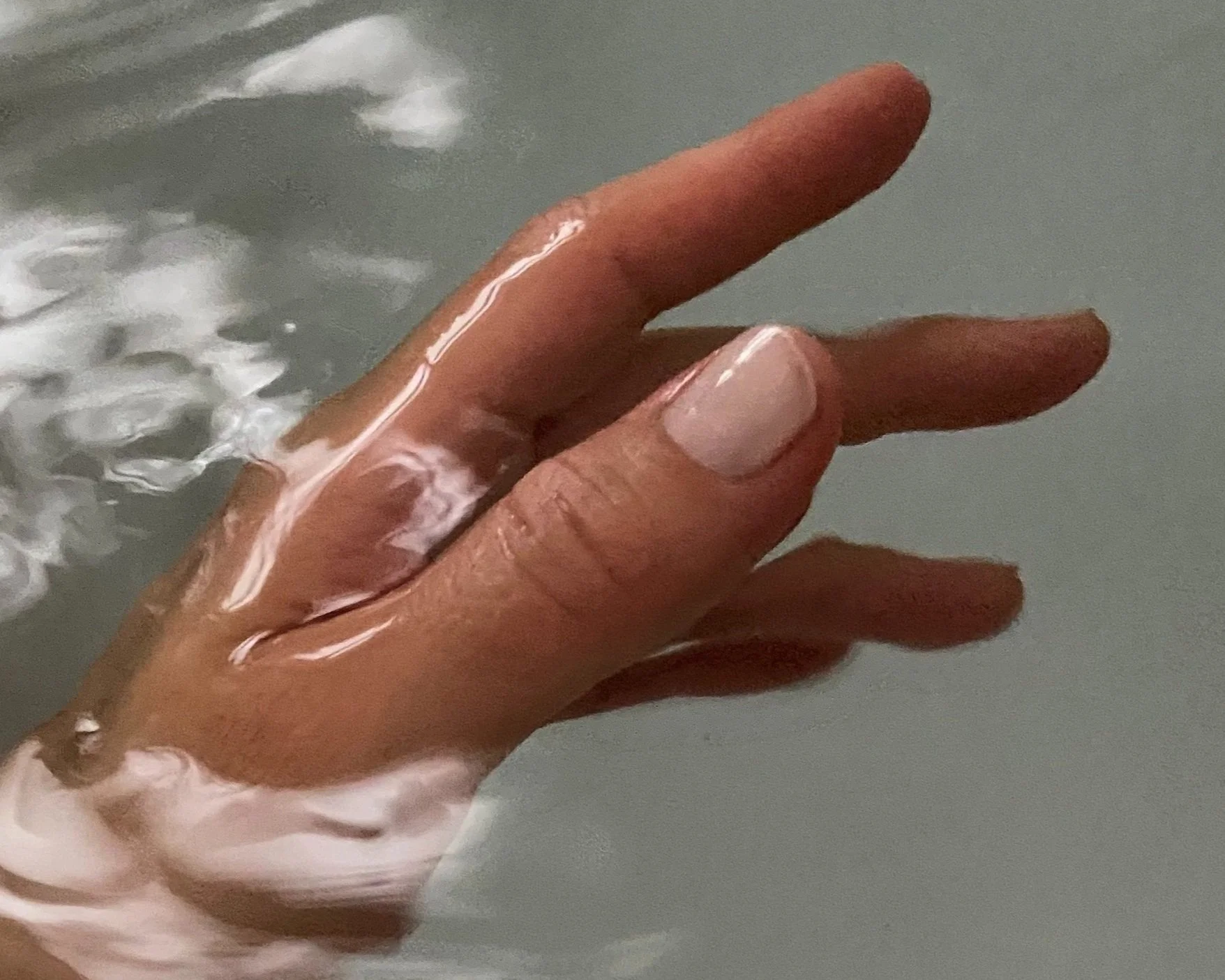 Hand in water illustrating Jodie Abrahams skin focused nutrition plans