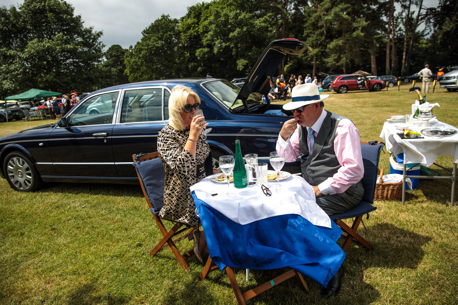  Racegoers eat and drink by their Bentley in a car park on day 3 of Royal Ascot on June 22, 2017 in Ascot. 
