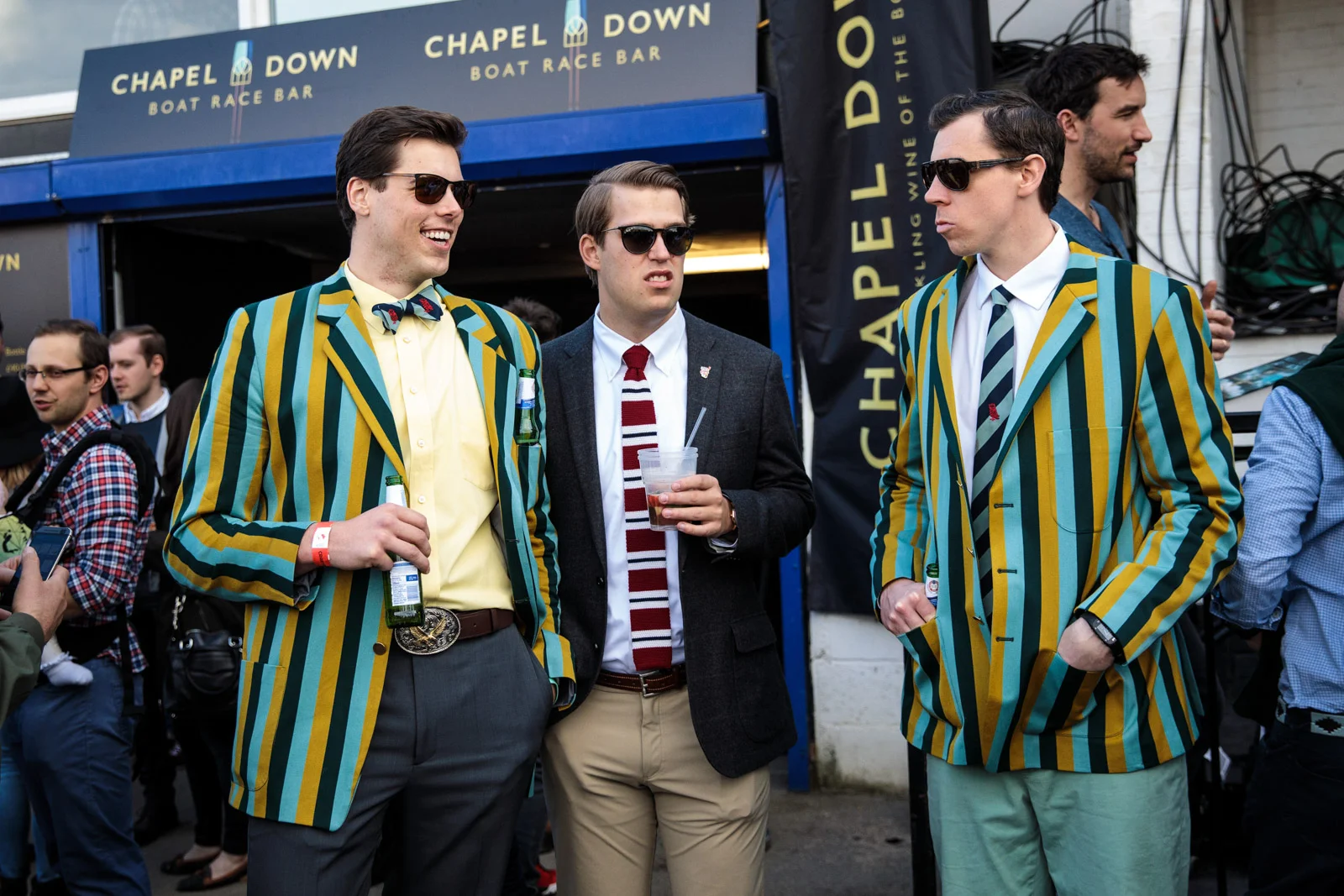 Spectators wearing boating blazers gather during the annual Boat Race between Oxford and Cambridge University along the River Thames in Putney on April 02, 2017 in London.