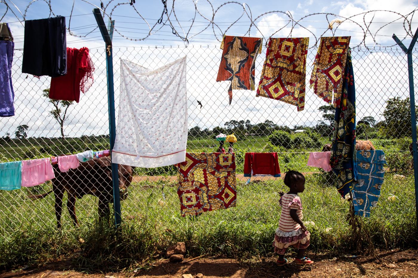 KYANGWALI, UGANDA: A young refugee from the Democratic Republic of Congo plays by a perimeter fence of the Kagoma reception centre on April 5, 2018.