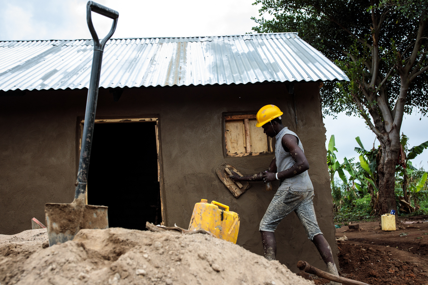  KYANGWALI, UGANDA: A young refugee from the Democratic Republic of Congo builds a shelter in the Kyangwali Refugee Settlement on April 3, 2018. 