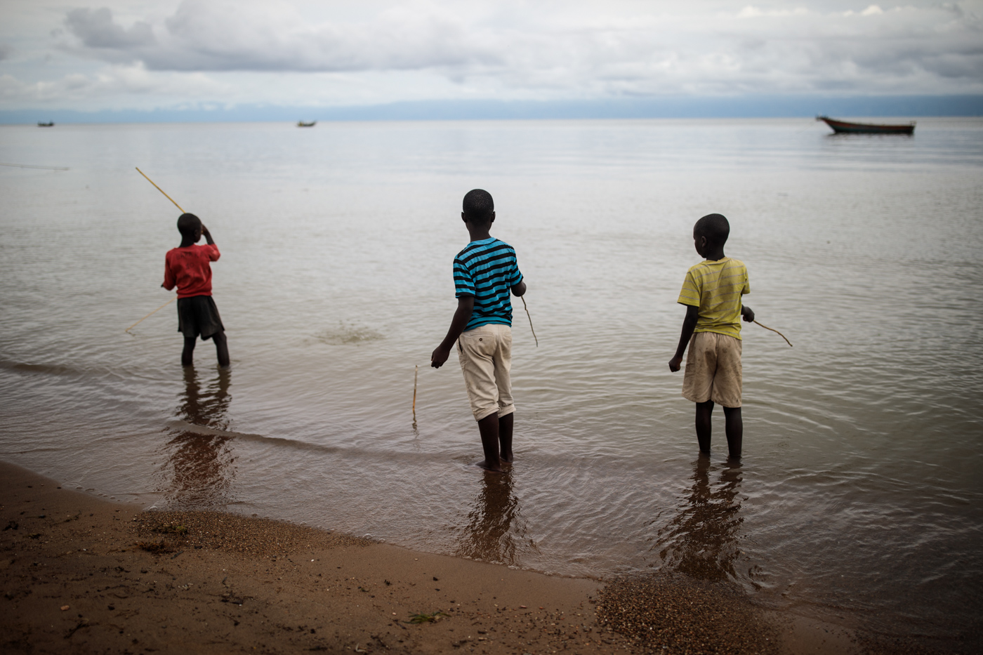  SEBAGORO, UGANDA: Local children play with home-made fishing rods on the banks of Lake Albert on April 4, 2018. 