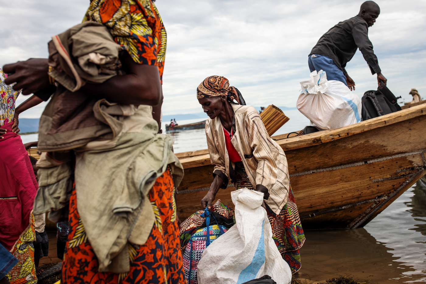 NSONGA, UGANDA: Refugees from Tchomia in the Democratic Republic of Congo gather their belongings as they arrive on boat at the Nsonga landing site on April 9, 2018.