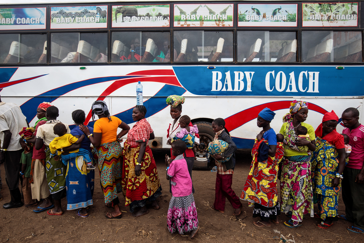  NSONGA, UGANDA: Refugees from the Democratic Republic of Congo board a bus from the Nsonga landing site to a reception centre on April 9, 2018. 