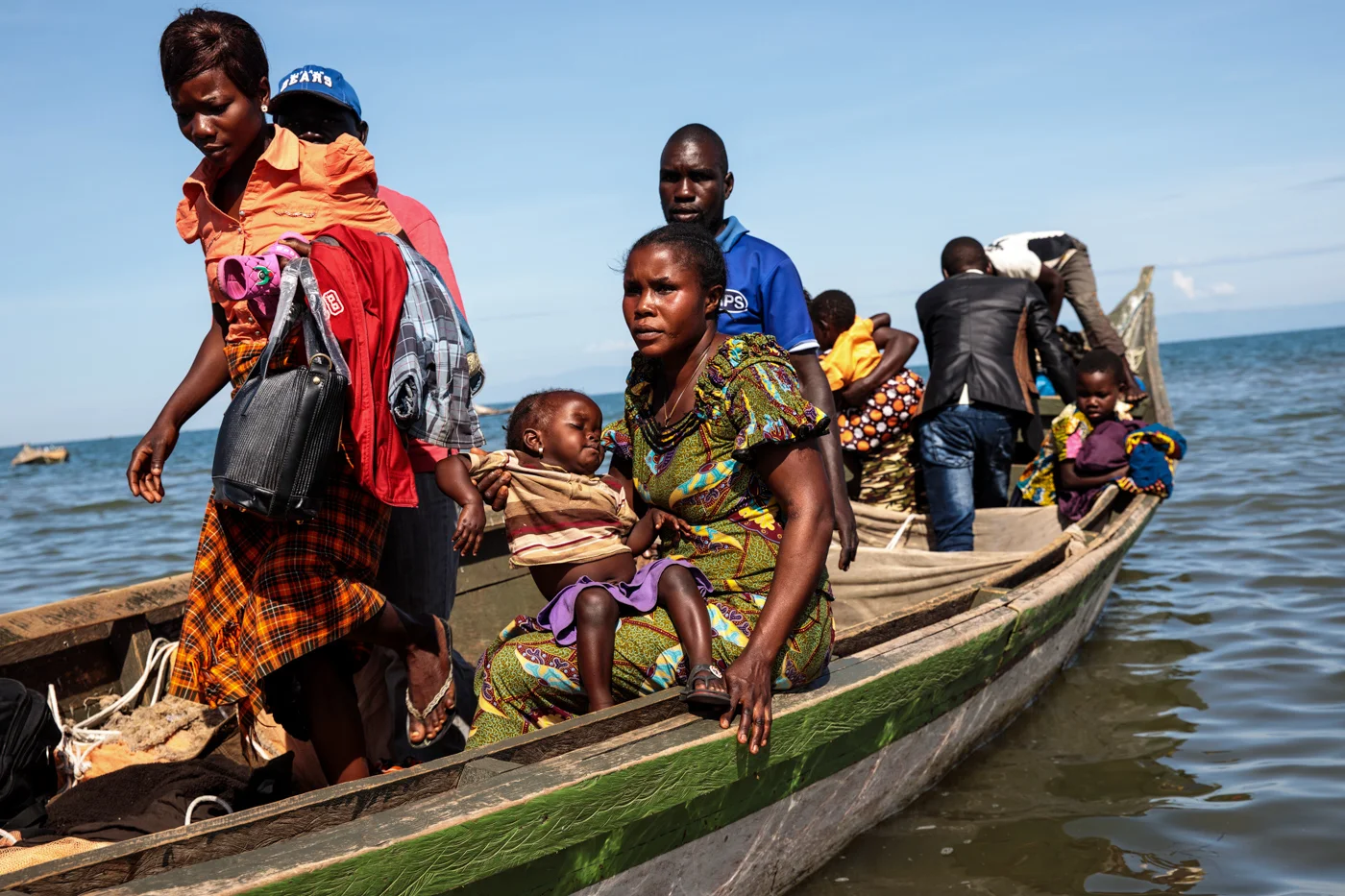 NSONGA, UGANDA: Refugees from Tchomia in the Democratic Republic of Congo arrive on boat at the Nsonga landing site on April 10, 2018.