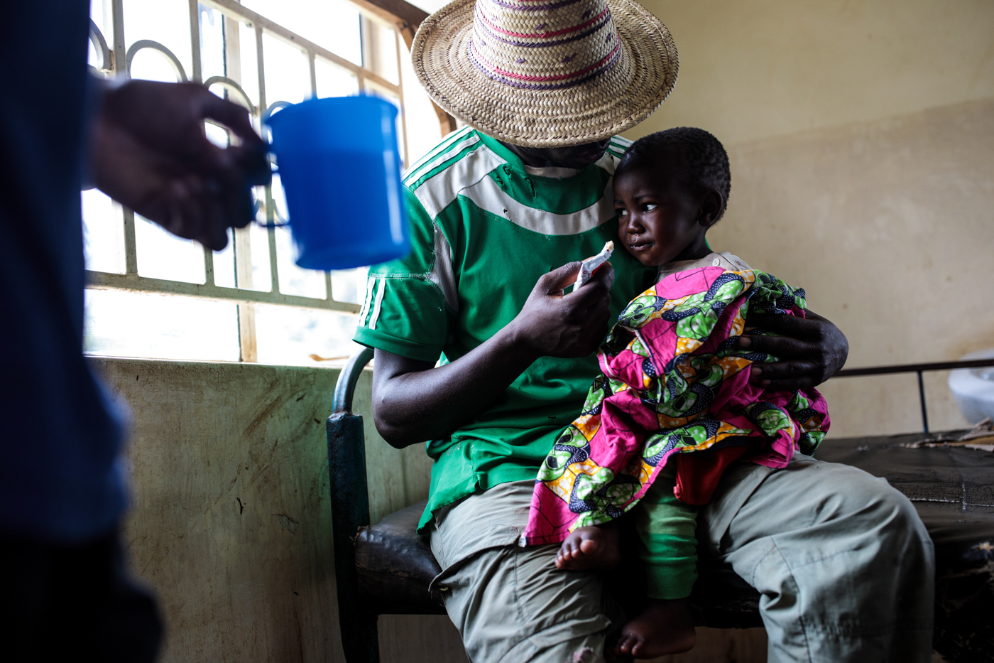  KYANGWALI, UGANDA - APRIL 06: A one-year-old refugee suffering from severe malnutrition is fed by her father at the Rwenyawawa Health Centre in the Kyangwali Refugee Settlement on April 6, 2018. 