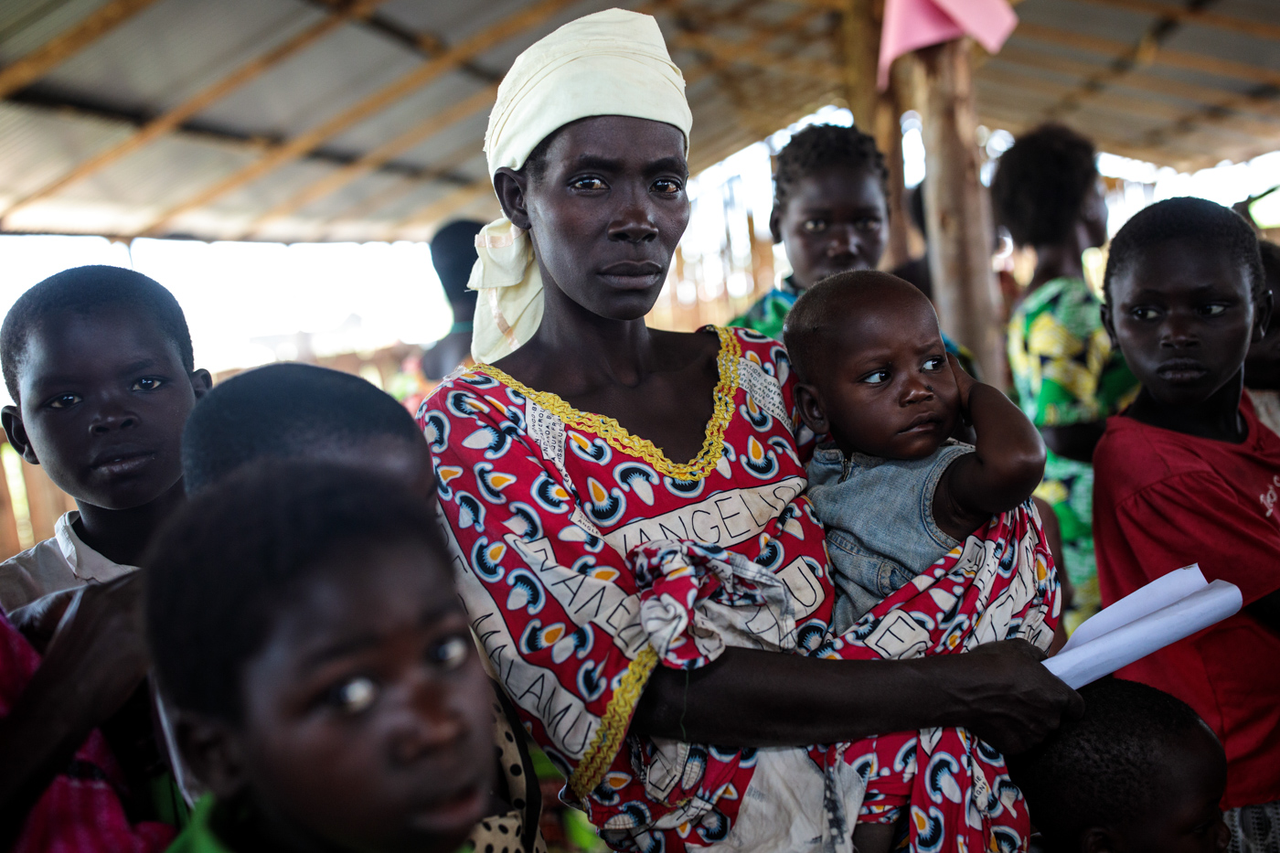  KYANGWALI, UGANDA: Refugees from the Democratic Republic of Congo wait with their children to be screened for malnourishment in the Kyangwali Refugee Settlement on April 6, 2018. 