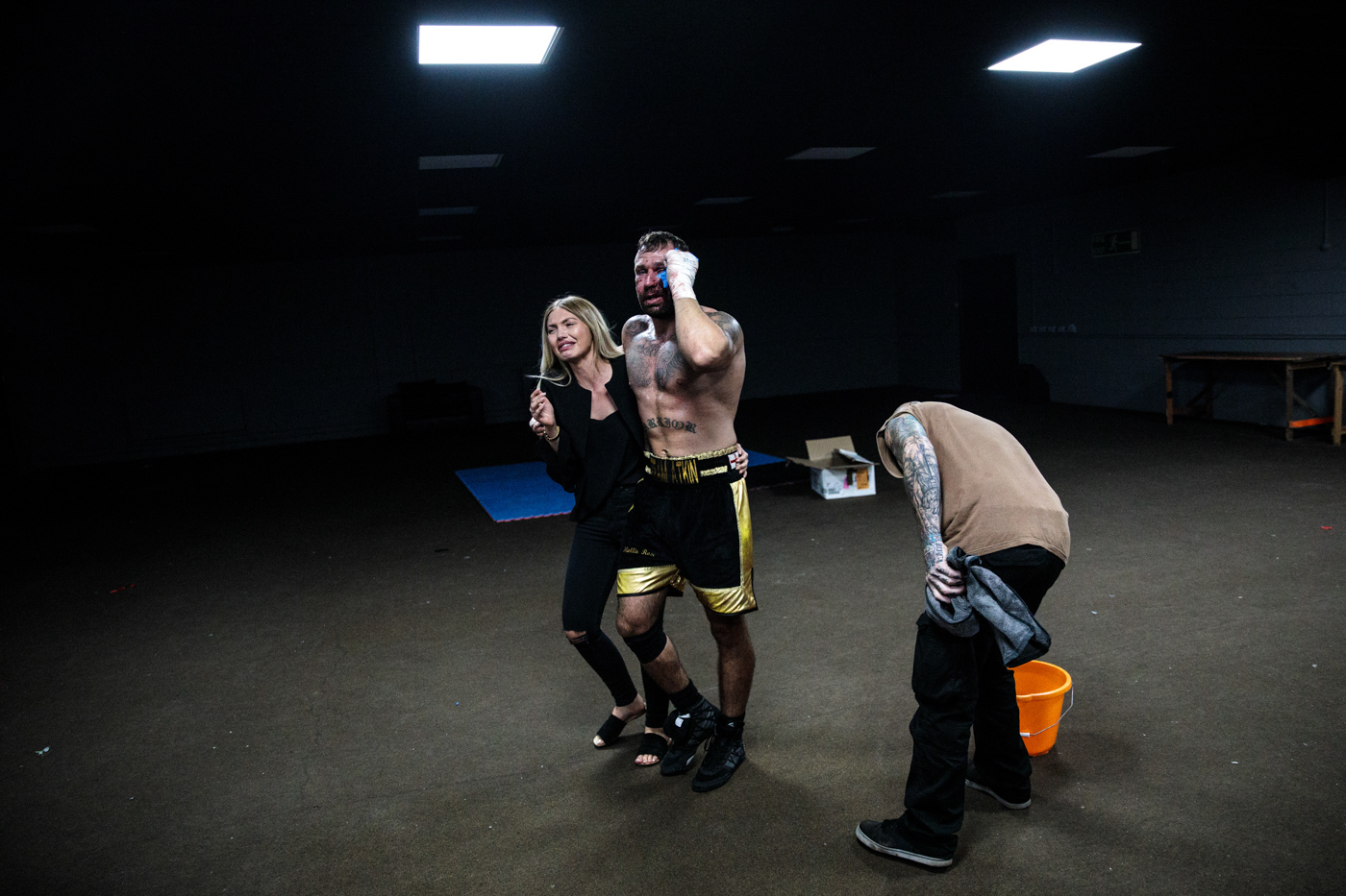 MANCHESTER, ENGLAND: Bare-Knuckle Boxier Luke Atkin, age 30 from York, is supported by his partner as he makes his way backstage after losing his Rogue Elite world title fight with Dom Clark during an Ultimate Bare Knuckle Boxing (UBKB) event at Bowlers Exhibition Centre on August 4, 2018.