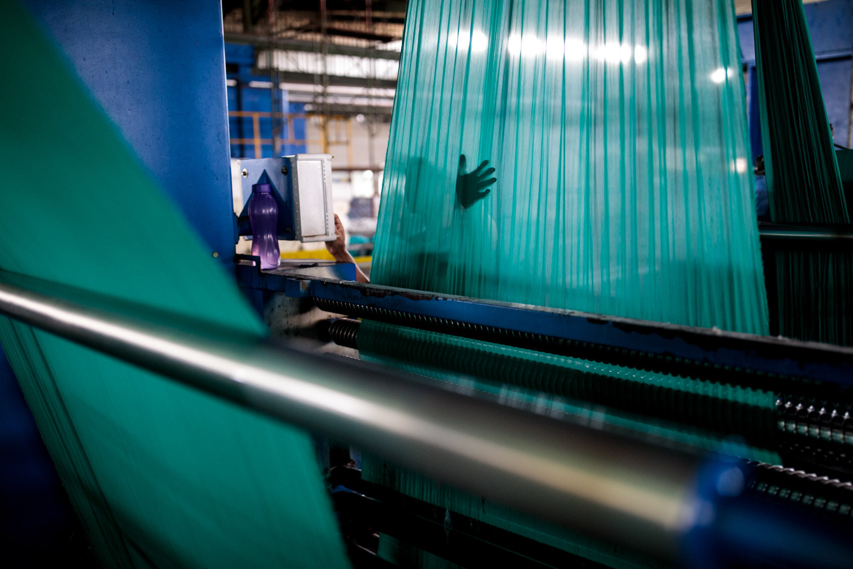  BANDUNG, INDONESIA: A man works at the Evergreen textile factory, which manufactures polyester fabric next to the Citarum River on November 22nd, 2019 in Bandung, Java, Indonesia.  