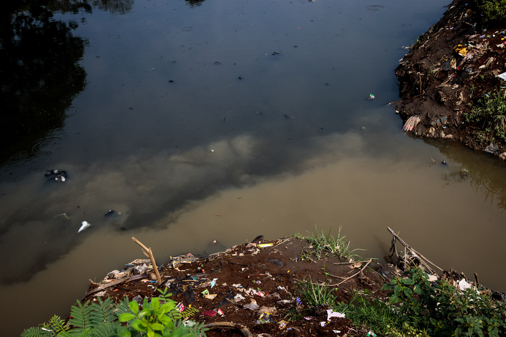  BANDUNG, INDONESIA: Discoloured black and brown water mix at tributary of the Citarum River on November 22nd, 2019 in Bandung, Java, Indonesia. 