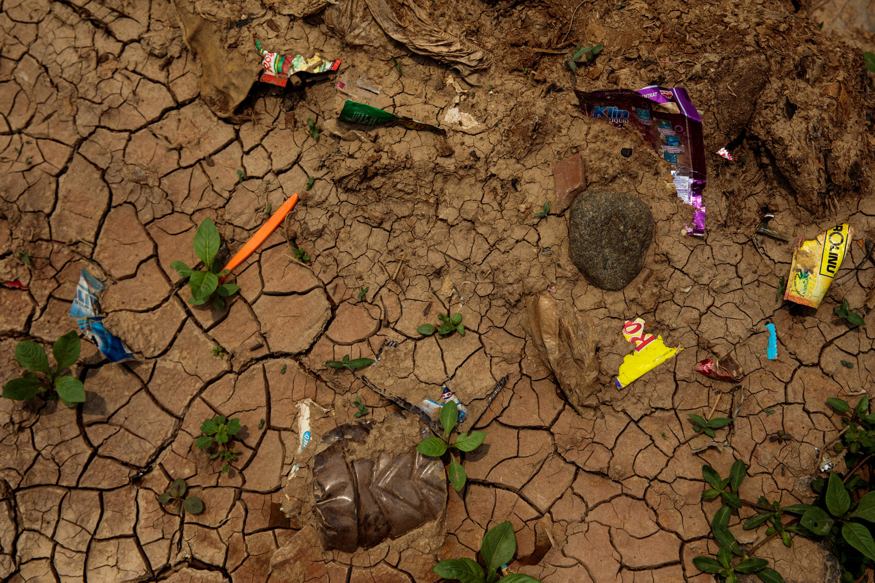  BANDUNG, INDONESIA: Plastic waste is embedded into the dry mud on the banks of the Citarum River on November 20th, 2019 in Bandung, Java, Indonesia.  