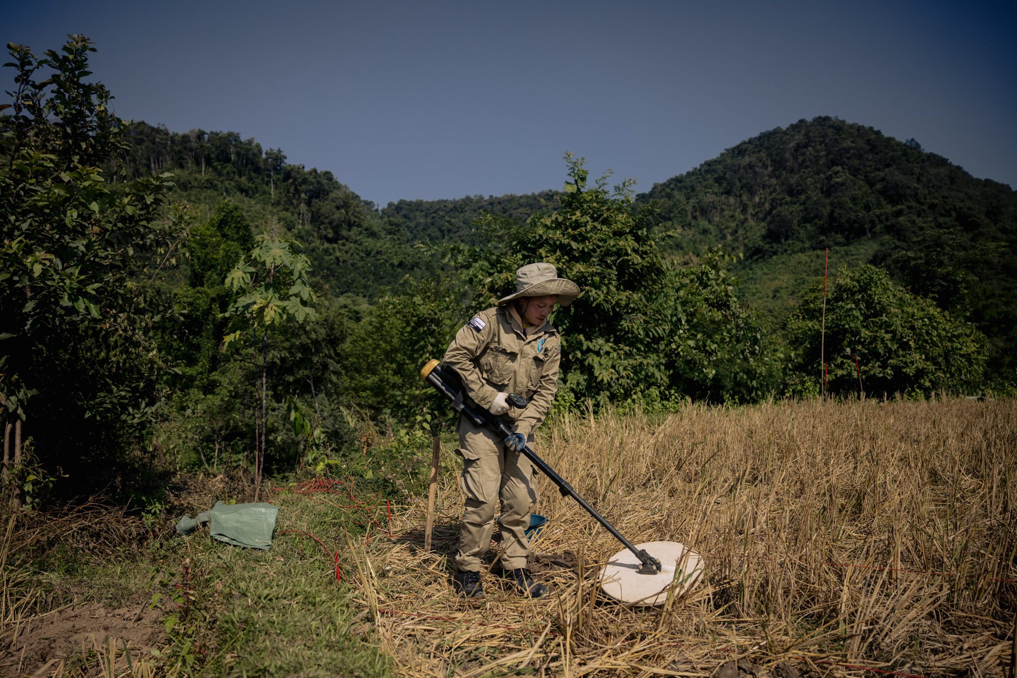  Field operator Phone Onkeo scans for UXO in a rice paddy near Muang Mai, Laos. 