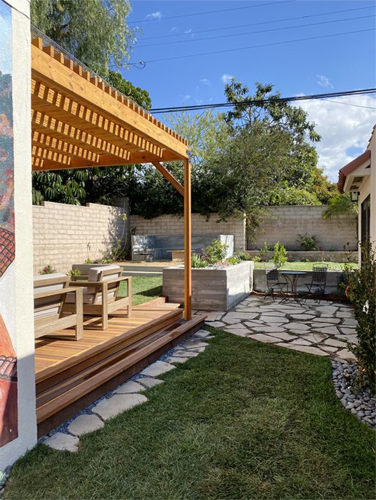  New deck, pergola, raised planter, lawn, hardscape, and planting in place of paved backyard 