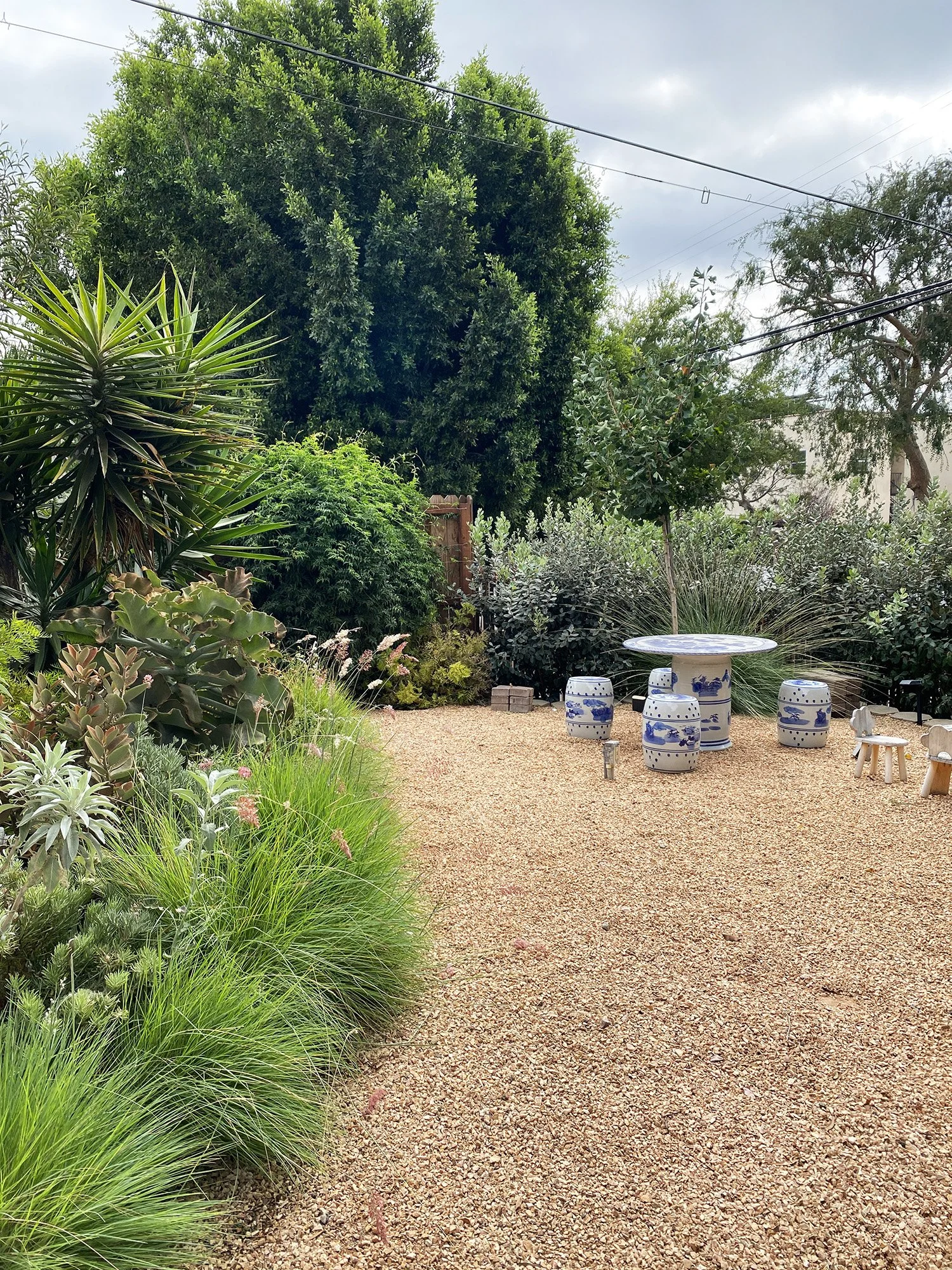 a front yard for gathering, working with "borrowed views" as neighboring trees become part of the greenery