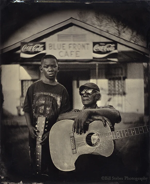 Jimmy "Duck" Holmes with grandson Eric Fox at his Blue Front Cafe started by his own parents in the 1940's in Bentonia, MS, making the Blue Front the oldest continuously-operated juke joint in Mississippi.