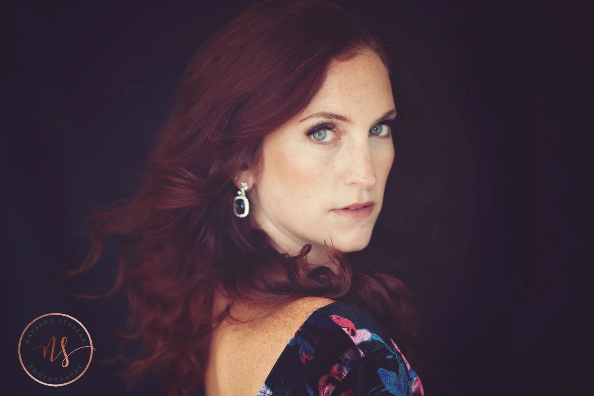 Amazing portrait close up of Cortney Chyme with red hair and blue eyes.