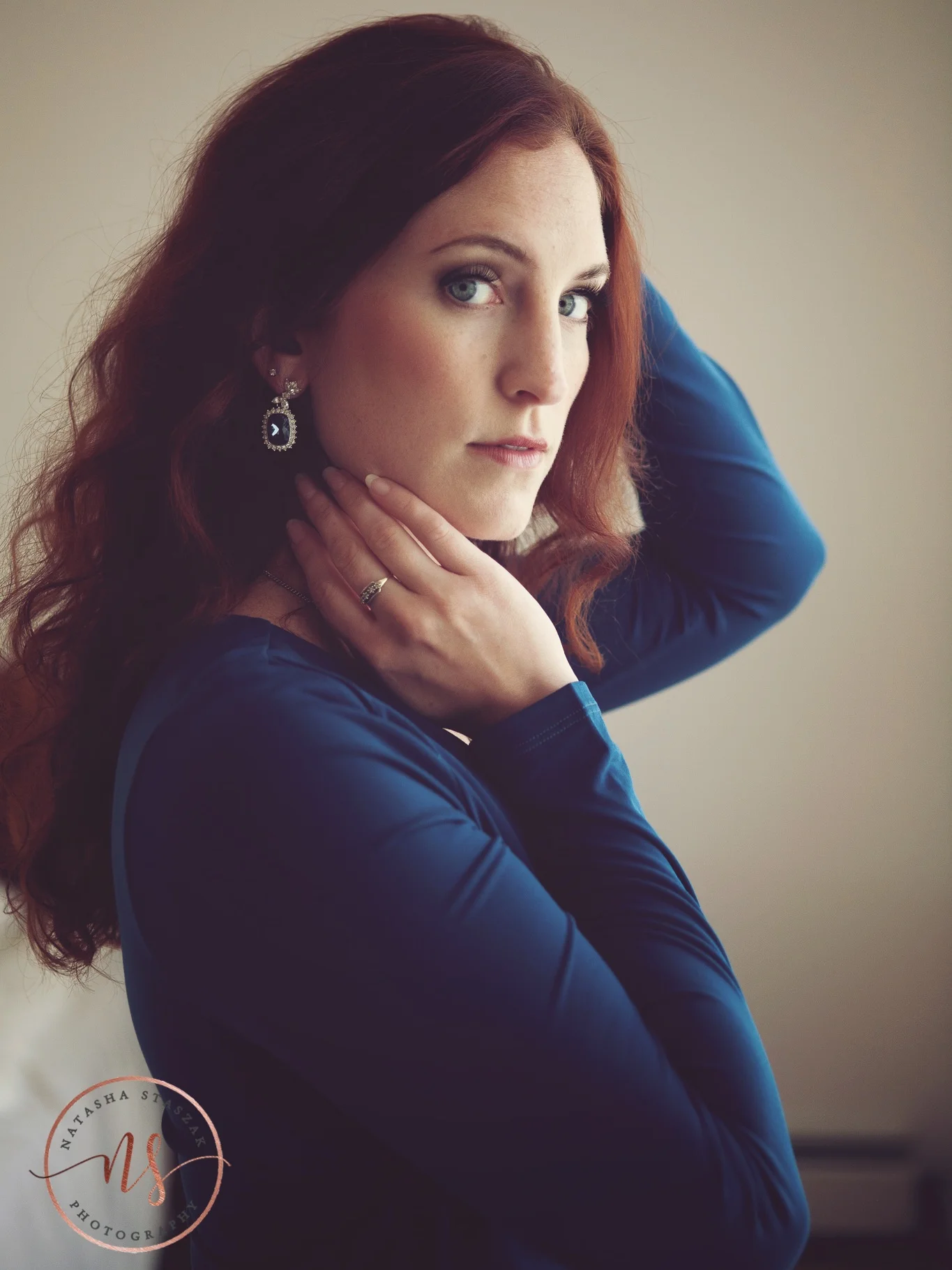 Moody portrait of Cortney Chyme in blue eyes and blue dress in Buffalo NY