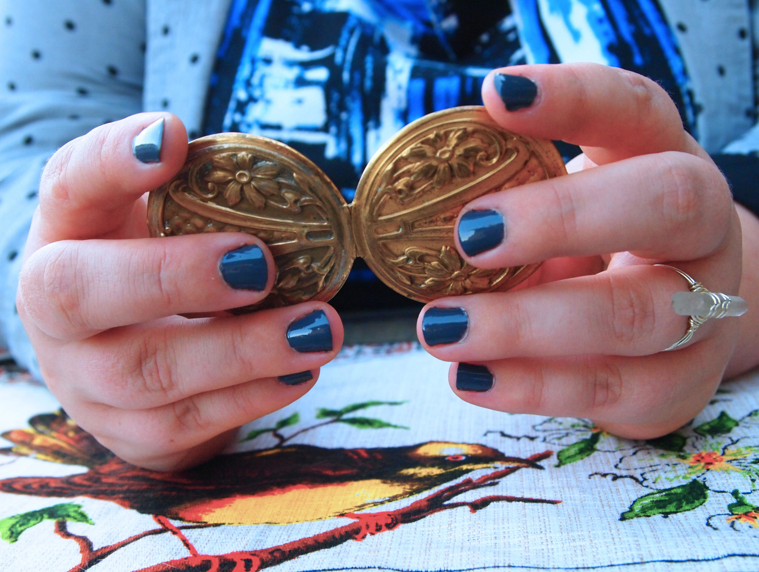 Tina's hands holding an antique locket.