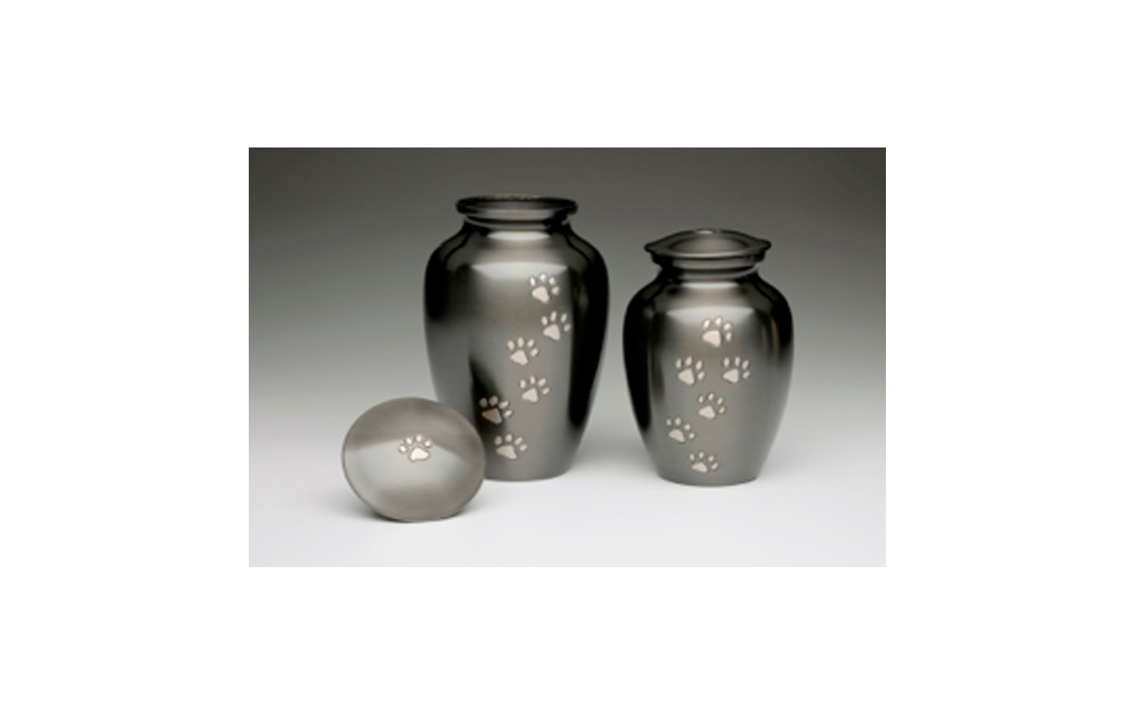 Paws To Heaven This urn is made of Brass with a Dark Slate Finish, Threaded Lid, and a Felt-Lined Base. This urn is available in Large, Medium, Small, XSmall, and Keepsake (see keepsakes) sizes. Large: Measures 8.75” H, 120 Cu. Inches, up to 115 lbs., $80 Medium: Measures 7.5” H, 70 Cu. Inches, up to 65 lbs., $70 Small: Measures 5" H, 30 Cu. Inches, up to 25 lbs., $62 XSmall: Measures 4.5” H, 15 Cu. Inches, up to 10 lbs., $50