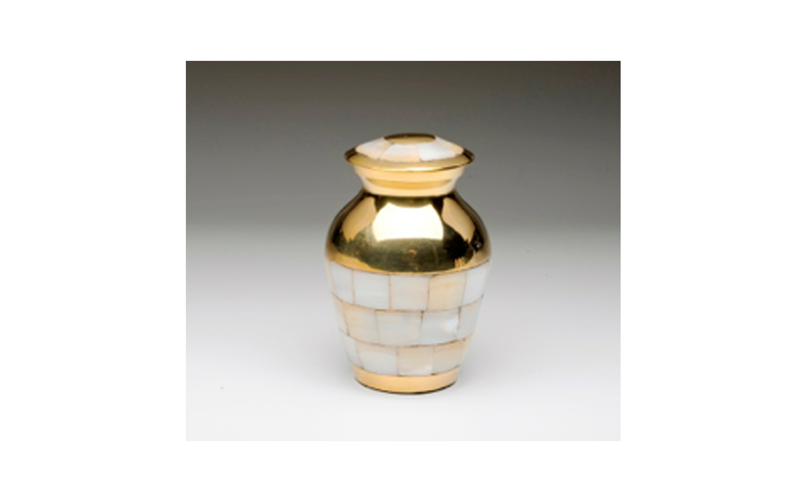 Mother of Pearl Golden Brass Keepsake This Golden Brass keepsake urn comes with a Beautiful Mother of Pearl Inlay, Threaded Lid, Felt-Lined Base, and a Velvet Box. Measures 3" H, 3 Cu. Inches, up to 2 lbs., $50