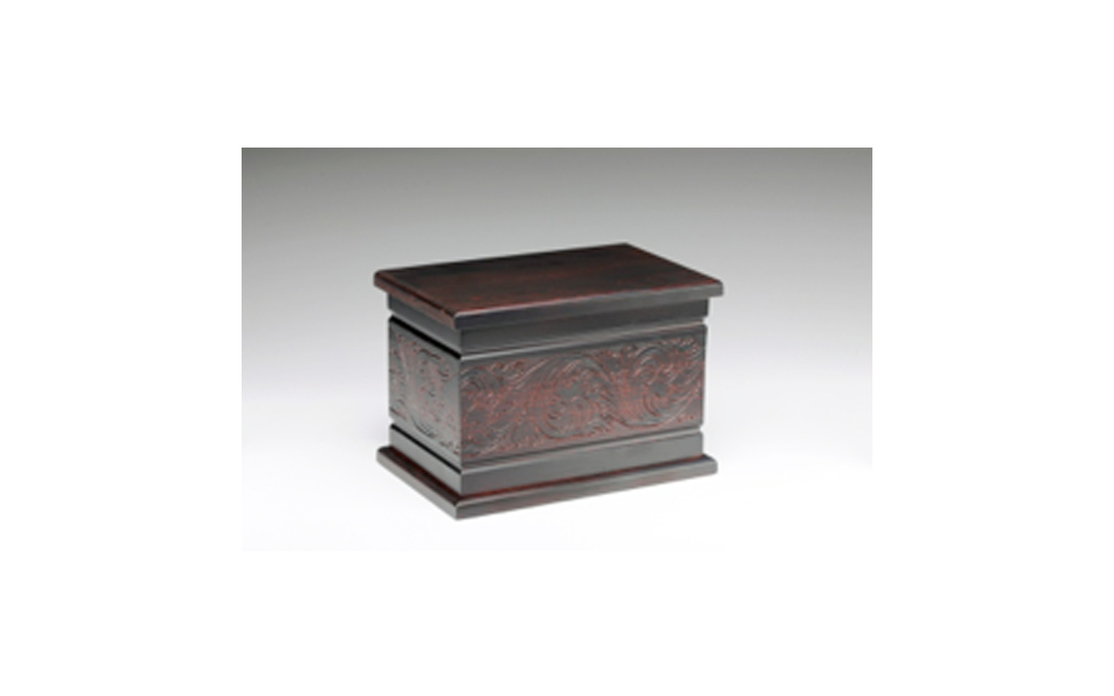 Northwoods Estonian Pine Dark Cherry This urn is made of solid pine and is stained with a dark cherry finish. This urn has a beautiful carved design. It opens at the base with a 3" wooden plug which securely screws in place. Measures 11" L x 7.25” W x 7.5” H, 300 Cu. Inches, up to 295 lbs., $175