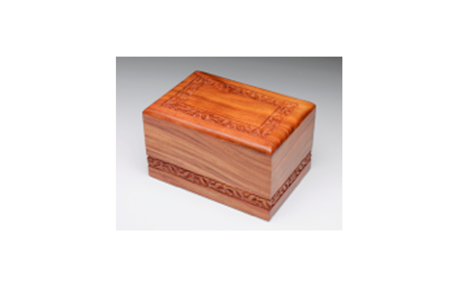 Hand-Carved Rosewood Urn Boarder Design This urn is hand-carved and made of solid rosewood. This urn has a slide out base. Measures 9.5” L x 6.5” W x 5.5” H, 220 Cu. Inches, up to 210 lbs., $155