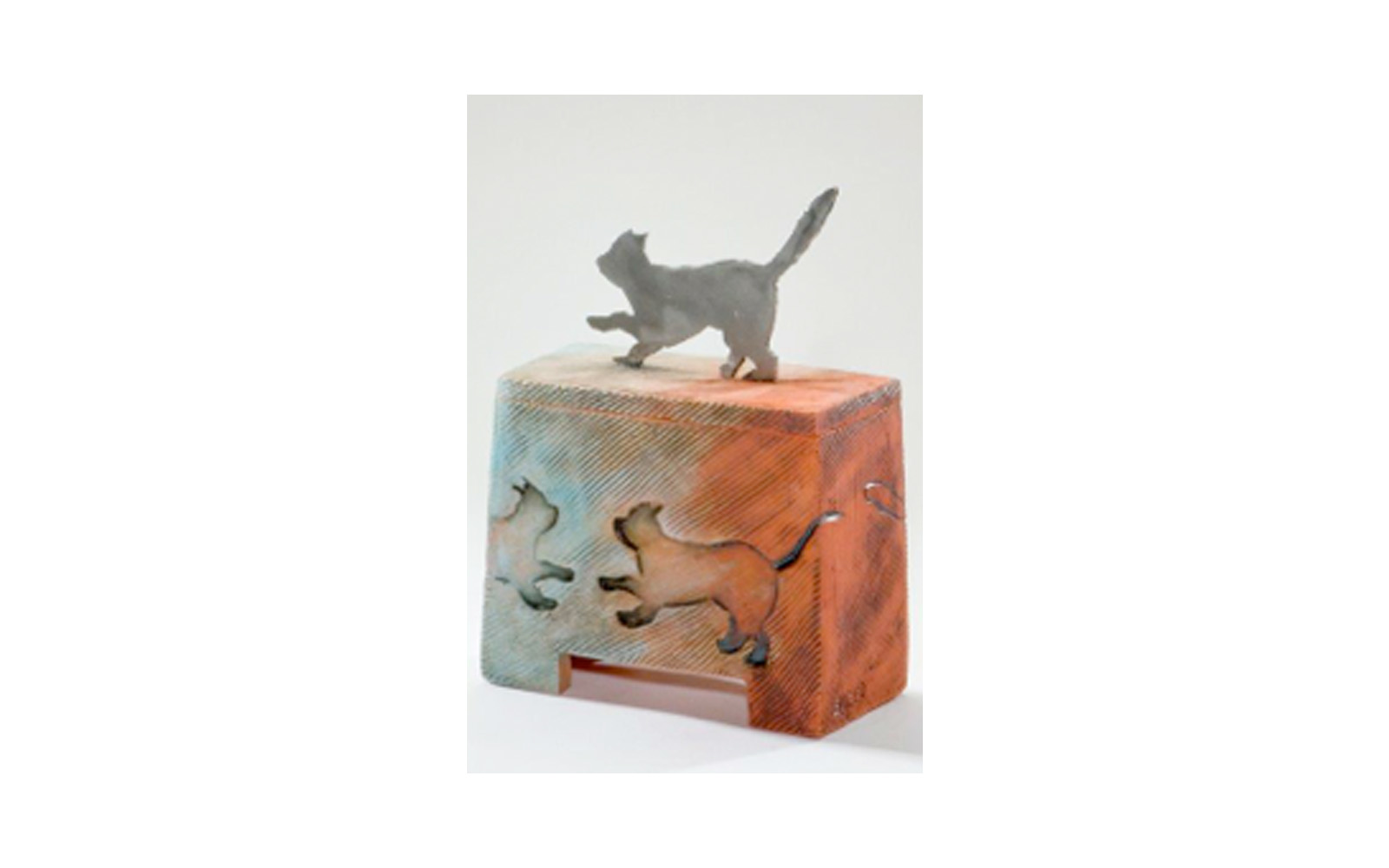 Kool Kat Ceramic Pet Urn This ceramic urn is Unique, Vibrant, and shows the Spunkiness of the cat. This urn has a Custom Metal Cat Cut Handle used to Imprint the sides of the urn. This urn measures 5 ¾” L x 2 ¾” W x 8 ¼” H, 35 Cu. Inches, up to 35 lbs. $365 *Please Note: Each piece is uniquely made by its Artist resulting in different colors and weight