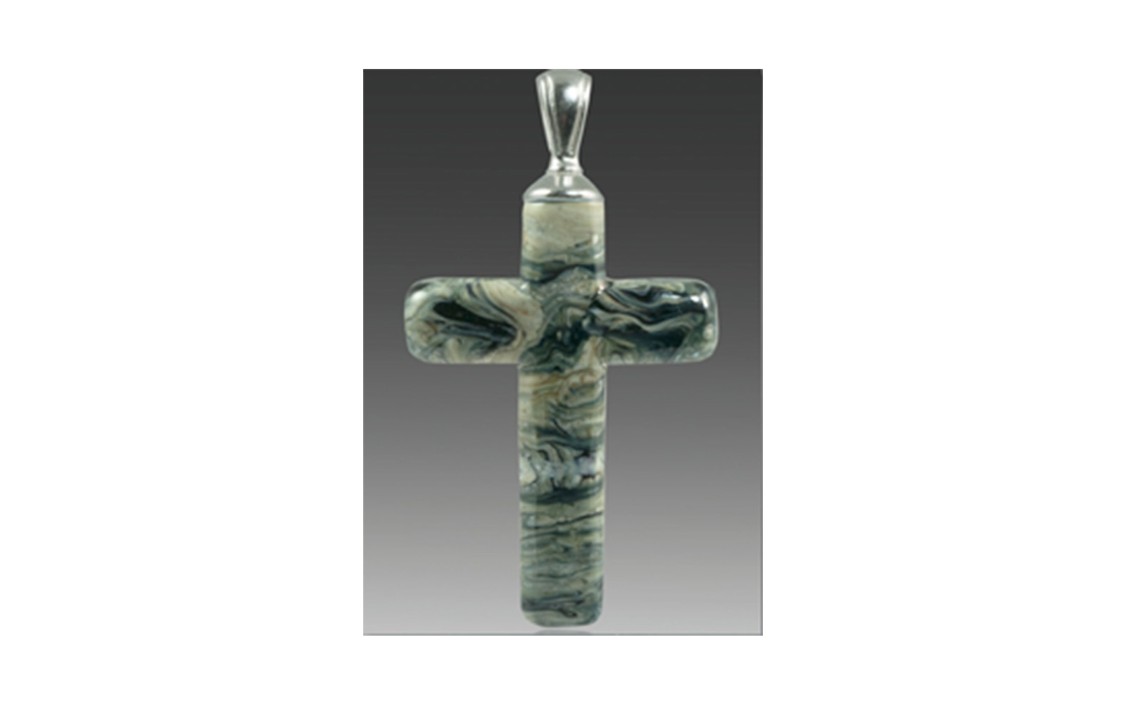 Cross Pendant The Cross Pendant is available in Calico, Turquoise, Fossil, or Black Granite colors and comes with a silver or gold, plated bail. It contains your loved one's cremated remains swirling throughout the pendant. Each is custom made to order and comes with a leather cord. Large: Measures 1 ¾” x 1”, not including the size of the bail $195 Small: Measures 1 ¼” x ¾” , not including the size of the bail $195