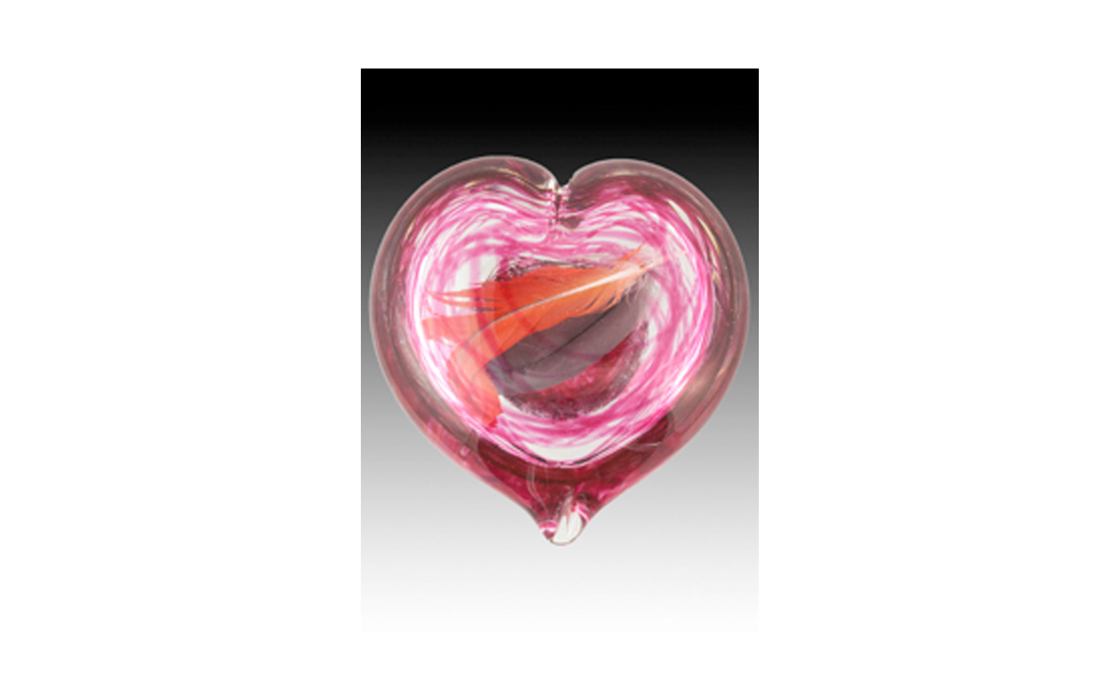 Gathering Heart Encased Memories in beautiful glass sculptures are now created as a way to preserve your precious memories. Items like flowers, dog tags, collars, leashes, feathers, fur clippings, and more can be showcased. After the piece is sculpted a small opening remains at the bottom to place your memory inside then it is sealed and encased forever. This keepsake comes in Blue, Aqua, Clear, Pulsar, Yellow, Green, Purple, and Red colors. Large Heart: 4.5” high & has an opening that is 1 1/2” wide. $290