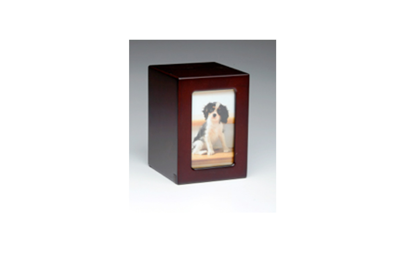 Wooden Picture Frame Urn This urn is made of engineered wood which is stained in a dark cherry finish. This wooden urn is very durable and comes in both large and medium sizes. Large: Outer Dimensions: 6.5" L x 4.75" W x 4.75" D, Inner Dimensions: 5.5" L x 3.75" W x 3.75" D Photo size: 5" x 3.25", 75 Cu. Inches, up to 70 lbs., $115 Medium: Outer Dimensions: 5.75" L x 4" W x 4.25"D, Inner Dimensions: 4.75" L x 3" W x 3.25" D Photo size: 4.5" x 2.75", 45 Cu. Inches, up to 40 lbs., $105