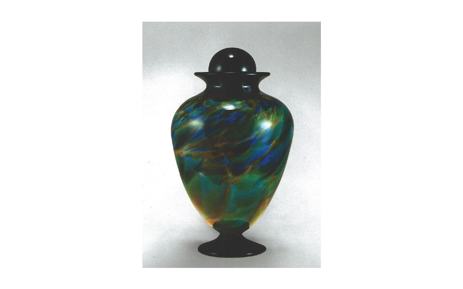 The Pacifica This piece is hand-blown with multiple deep jewel tones. Due to the unique nature of each urn's material, there are variations in color and size for each piece. Measures: 6.5"D x 12" H, 220 Cu. Inches, up to 220 lbs. $775