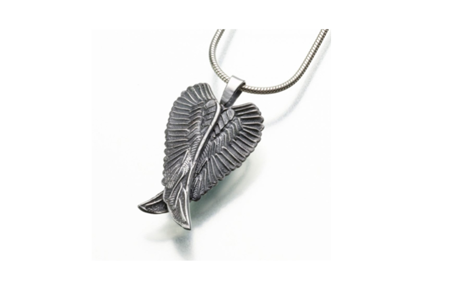 Angel Wings Urn Pendant This pendant measures 3/16"W x 1-3/16"H and comes in both sterling silver or gold vermeil. Has a threaded opening in the back to fill with ashes or hair of your beloved pet. Sterling Silver: $215 Gold Vermeil: $225