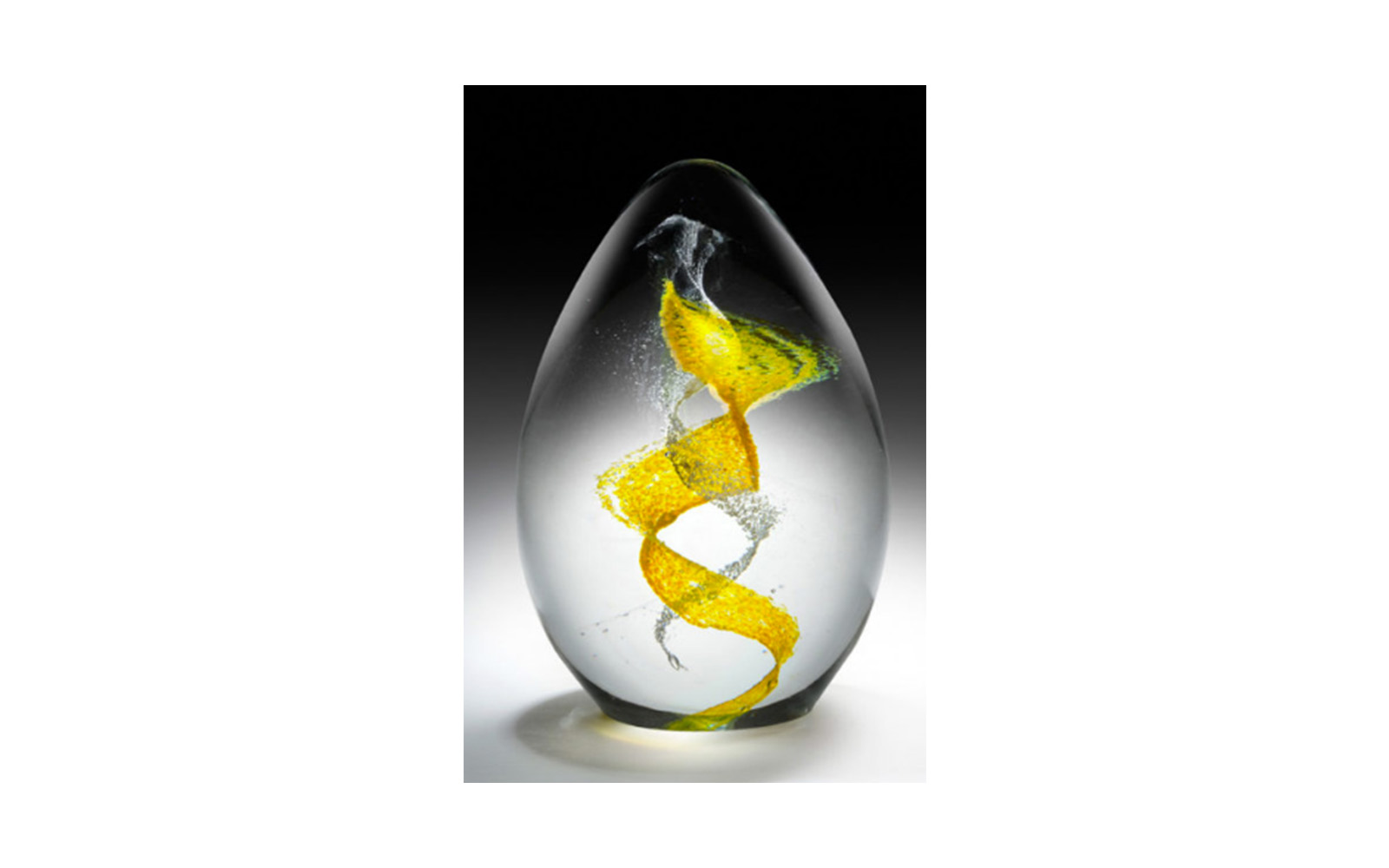 Blown Glass Egg Uniquely handmade this egg will memorialize your beloved pet with a DNA swirl through the center. This memorial displays a warm sparkle when it sits on a LED light base. This piece comes in mini, small, medium and large sizes and can be engraved at no cost to you. The colors available to select from are: red, orange, yellow, green, light blue, dark blue, violet, white, black and pink. A secondary color can be added for an additional $25 and 23K gold leaf can be added if it's the secondary color for an additional charge of $75 . Mini Egg: Measures 3" Tall, $200 Small Egg: Measures 5" Tall, $600 Medium Egg: Measures 6.5" Tall, $800 Large Egg: Measures 8" Tall, $1,200