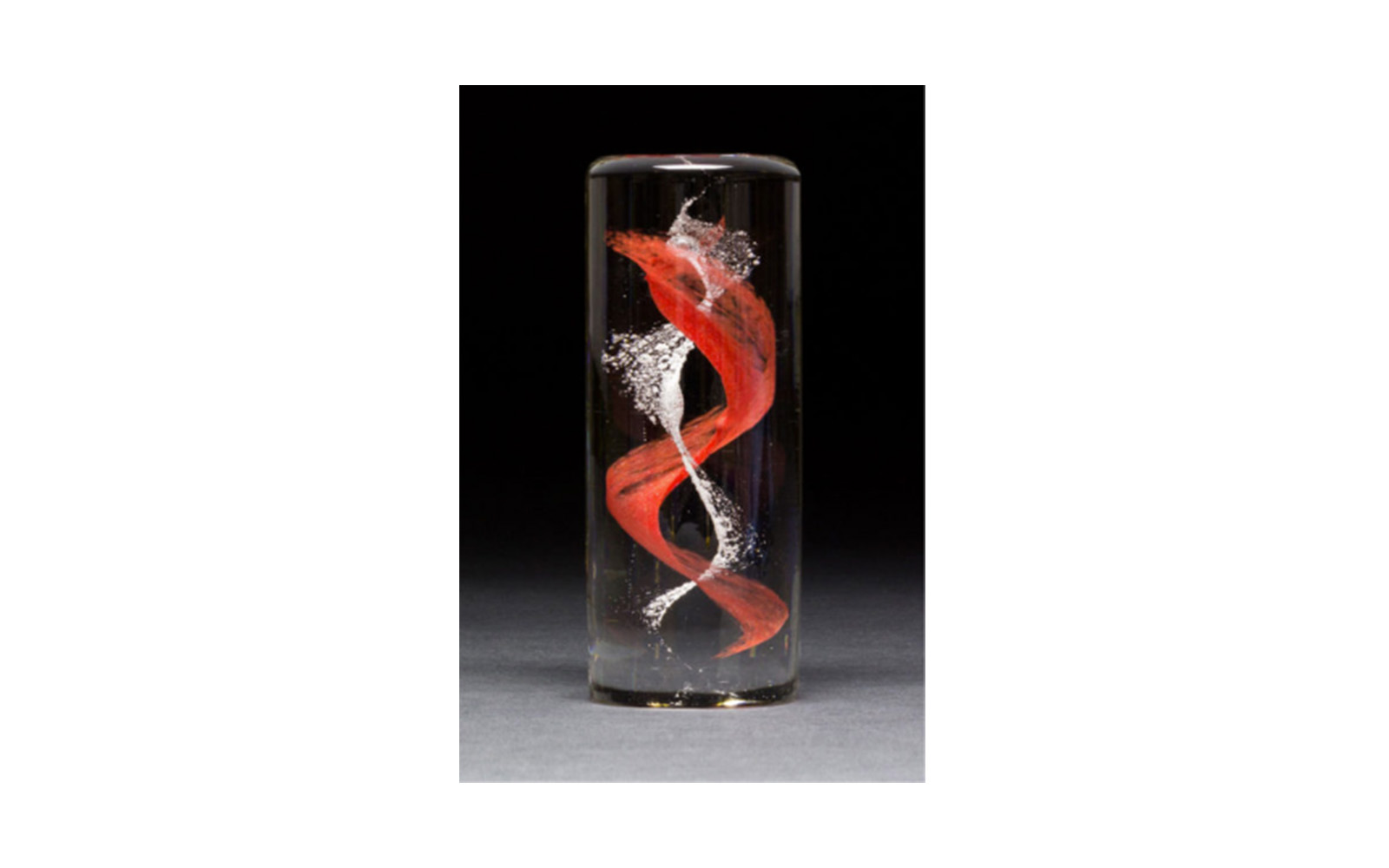 Blown Glass Cylinder Uniquely handmade this cylinder will memorialize your beloved pet with a DNA swirl through the center. This memorial displays a warm sparkle when it sits on a LED light base. This piece measures 5"T x 2"D and can be engraved at no cost to you. The colors available to select from are: red, orange, yellow, green, light blue, dark blue, violet, white, black and pink. A secondary color can be added for an additional $25 and 23K gold leaf can be added it it's the secondary color for an additional charge of $75. Glass Cylinder: $300