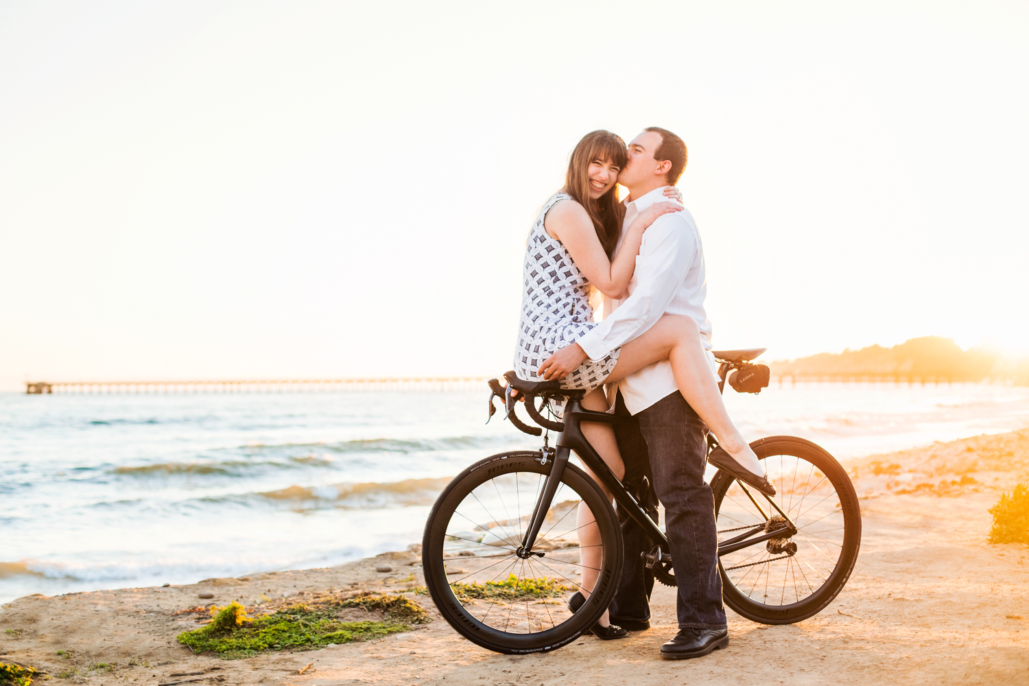 Cute engaged couple on bike in santa barbara