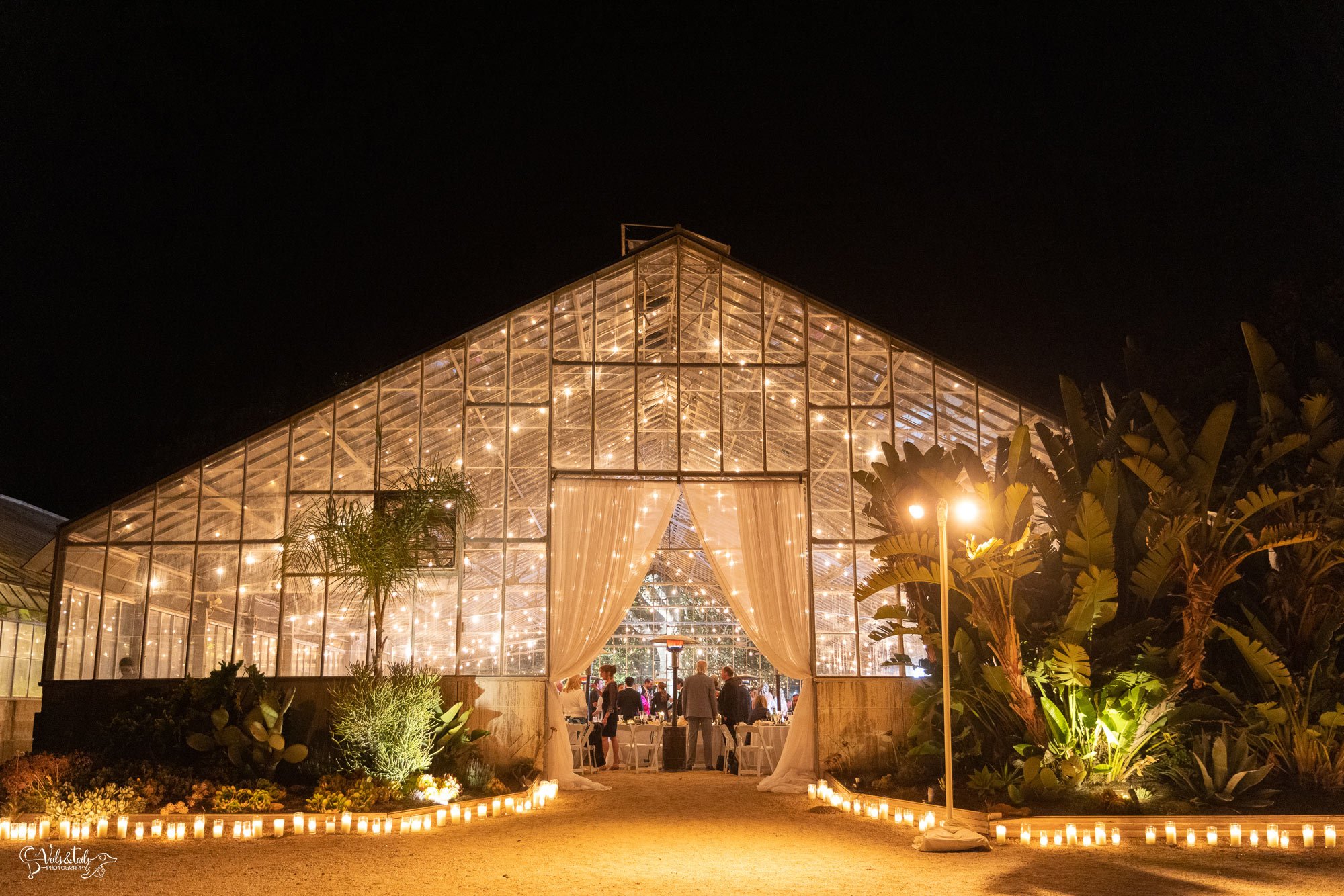 Dos Pueblos Orchid Farm Wedding - Santa Barbara Photographer  - night greenhouse reception twinkle lights candles exterior