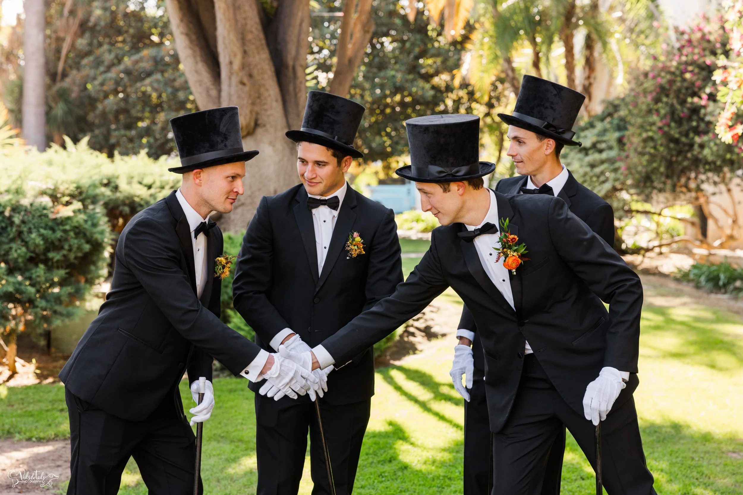 joyful Santa Barbara Wedding Photographer Courthouse groomsmen in tophats