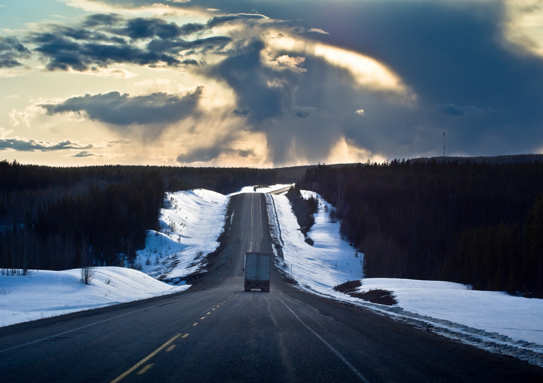 Snow Bordered Road & Stormy Sky
