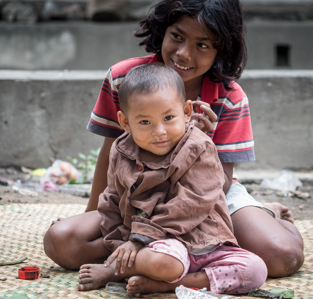 Squalor & Smiles. Sat on a little mat by a stinking stream... Photo! Photo! They shouted....