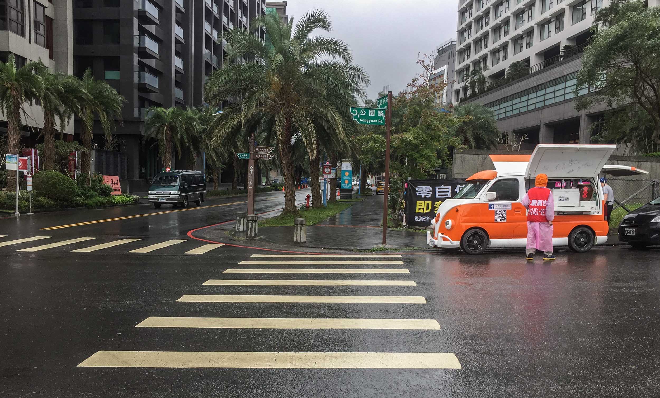 A snack van packing up in the rain.... cute little vehicle.