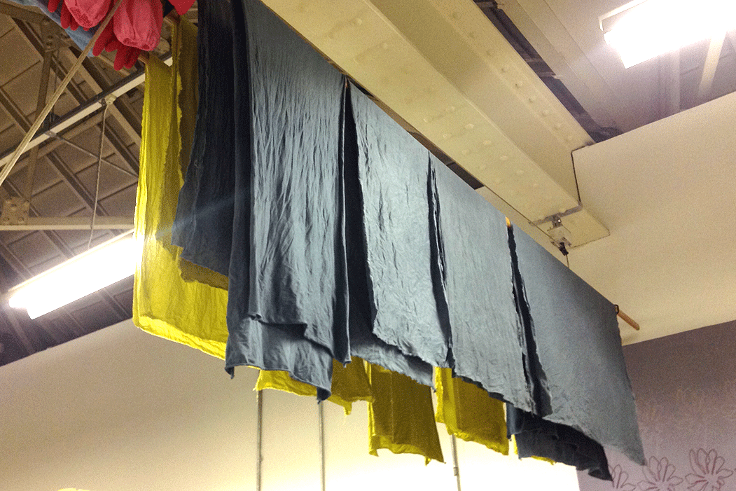 Our dyed fabric, drying on a traditional drying pulley (spot one of Joanna's amazing wool hangings on the wall to the right).