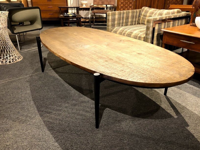 Reclaimed wood oval coffee table on crafted metal base