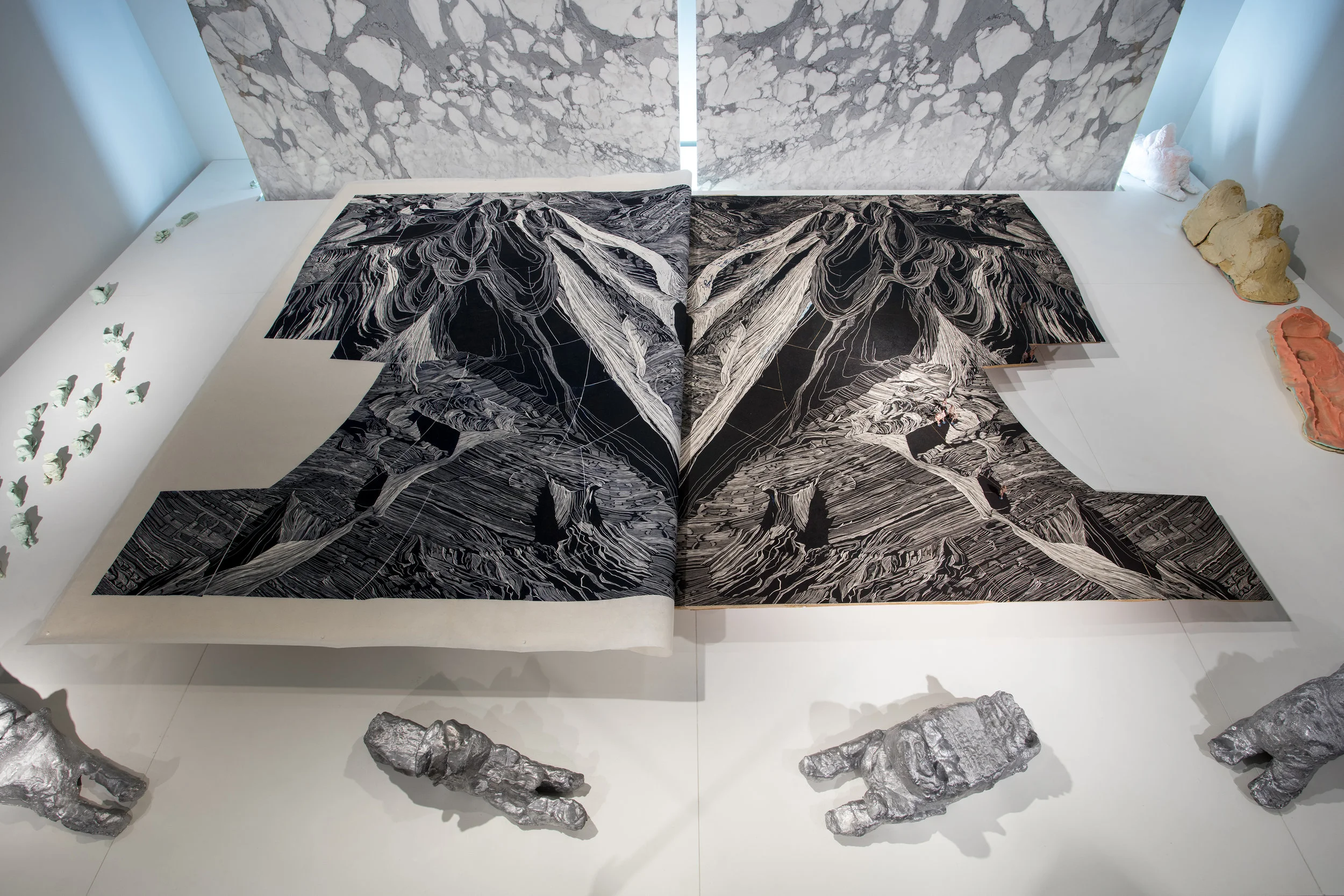 Linocut block and print, aluminum casts made from playdough snowmobile by Lachaolasie Akesuk (age 16), Nathan Adla (age 13), and Christine Adamie (age 13), handwritten notes of Embassy of Imagination dreams, calacatta marble